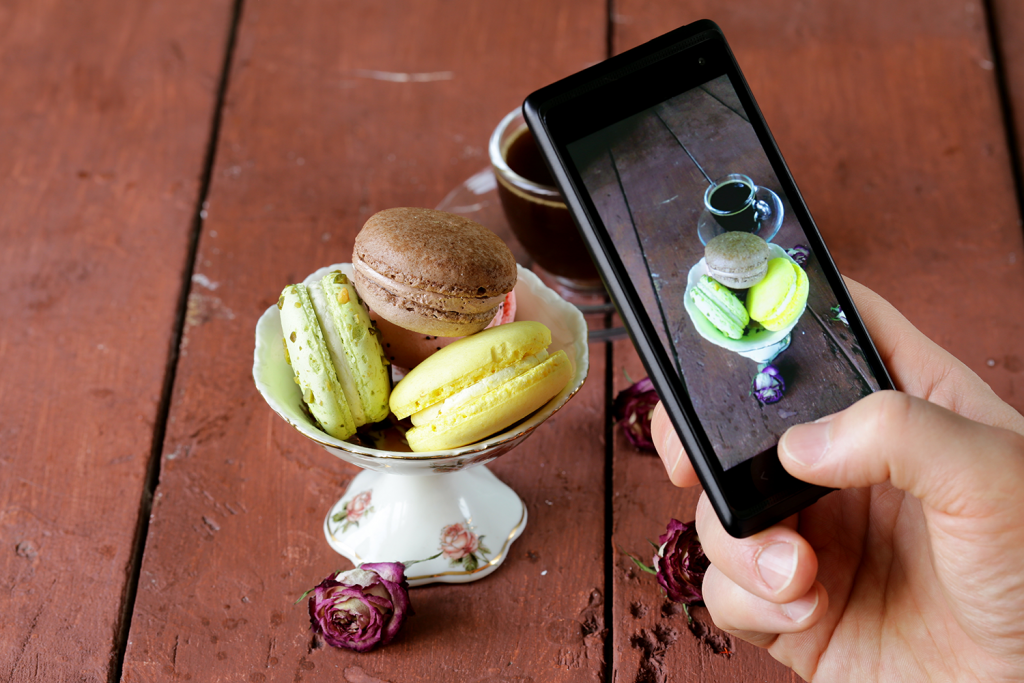 A phone takes a photo of a macaron dessert special