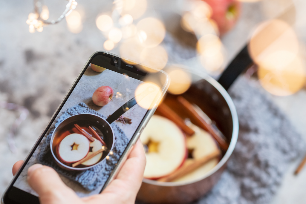 An iphone taking a photo of a tasty restaurant dish