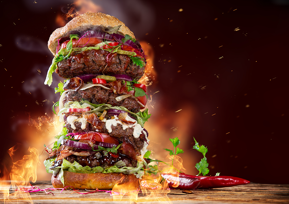 A giant hamburger surrounded by flames