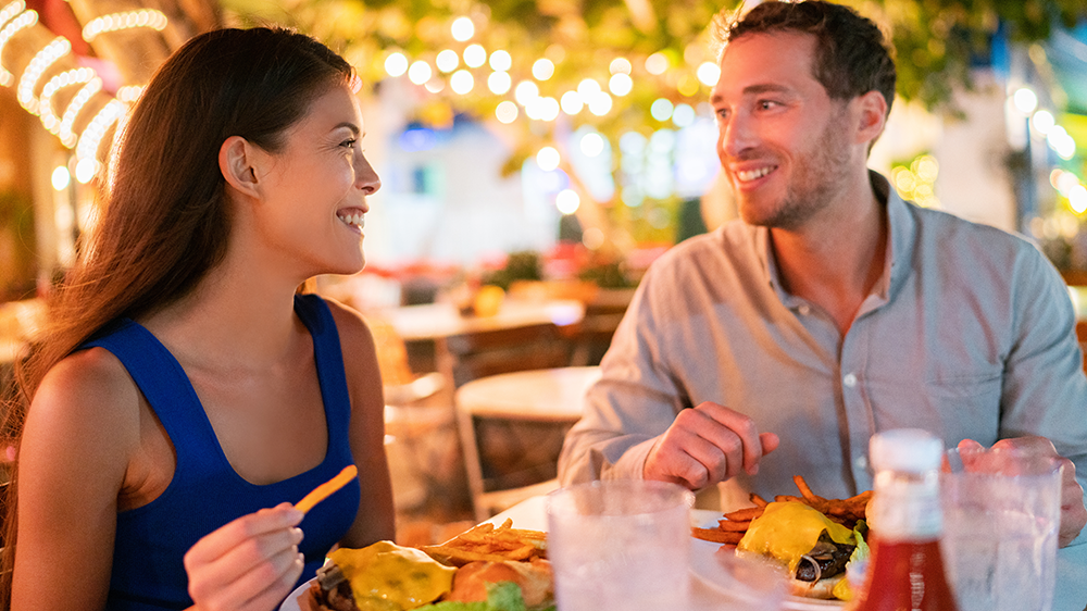 Two traveling tourists enjoying dinner at a local restaurant