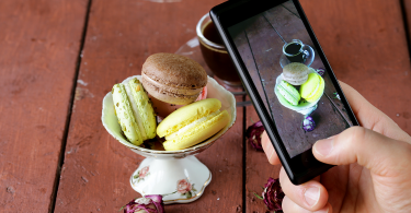 A phone takes a photo of a macaron dessert special